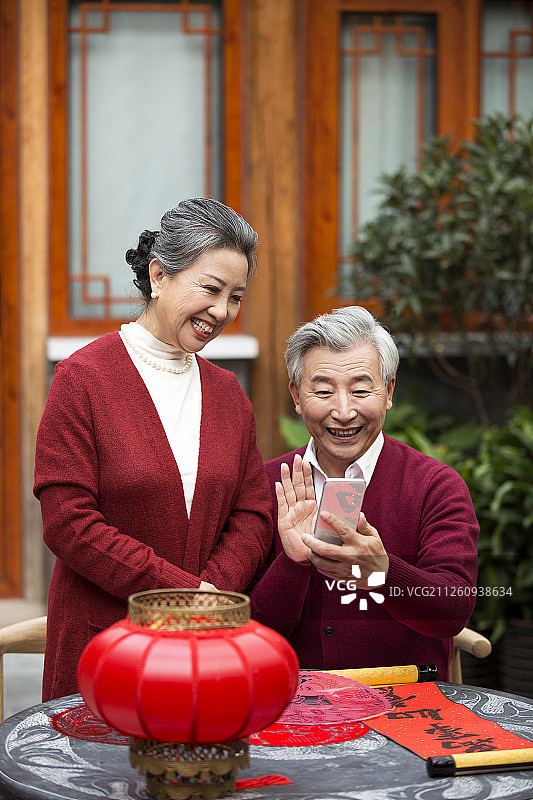 老年夫妇新年用智能手机视频对话图片素材