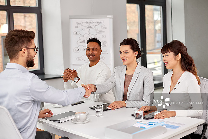 招聘与雇佣概念：招聘团队面试男员工并在办公室握手图片素材