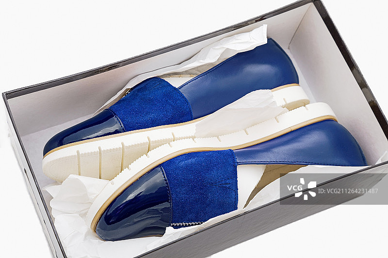 白色背景上盒子里的时尚舒适蓝色女鞋图片素材