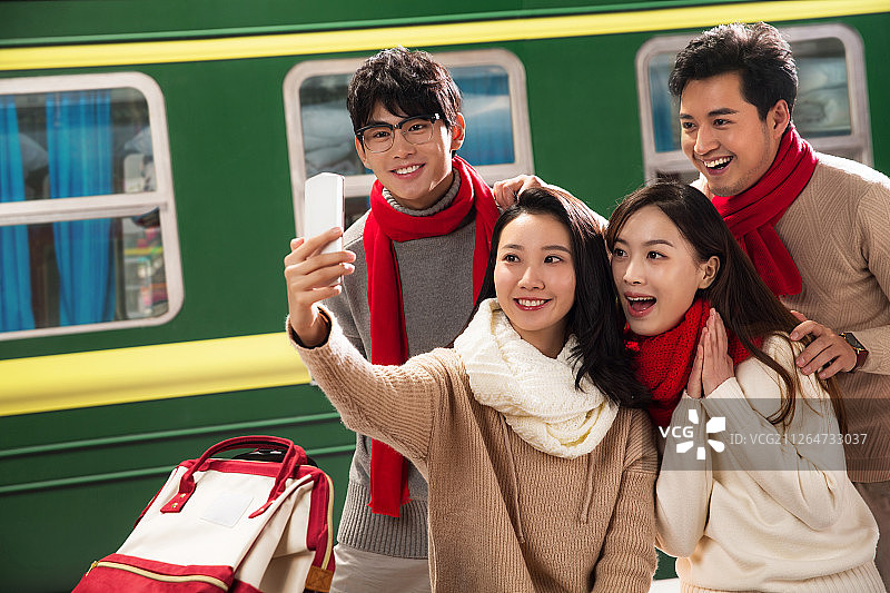 青年男女在火车站台上用手机图片素材