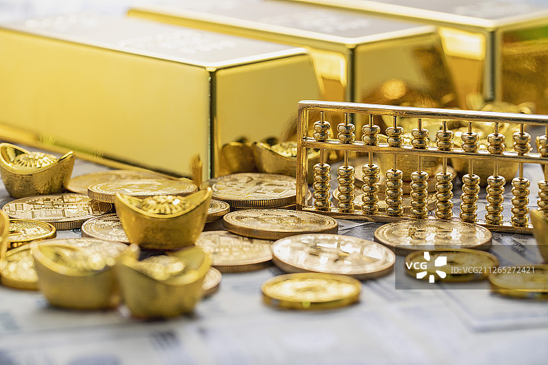 美金纸钞上面对垒了大量金币元宝金块和算盘图片素材