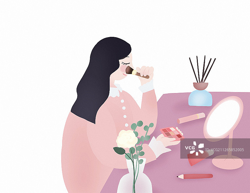 少女在桌前拿化妆刷对着镜子化妆的日常图片素材