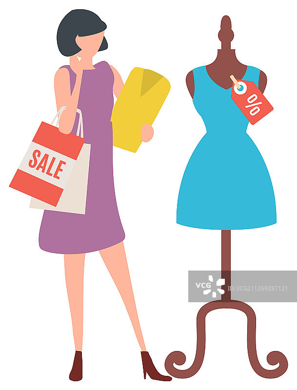 女人在商店看人体模型上的连衣裙图片素材