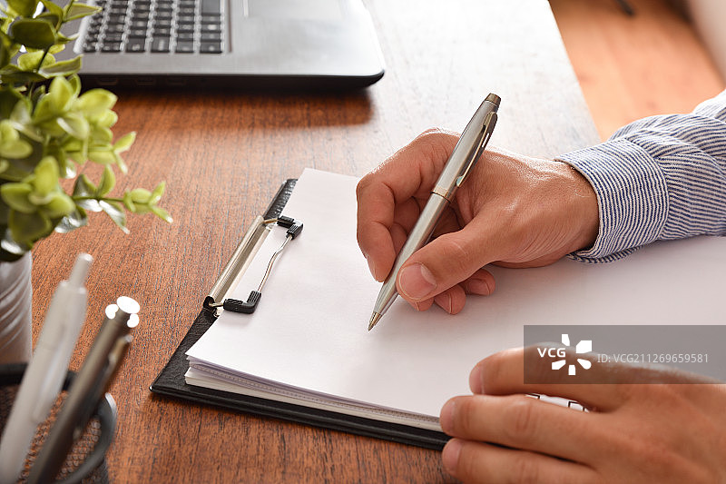 工作中的商人，在纸上书写图片素材