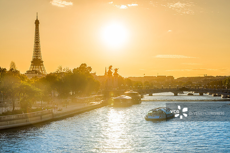 法国巴黎：日落时分的河上船舶景观图片素材