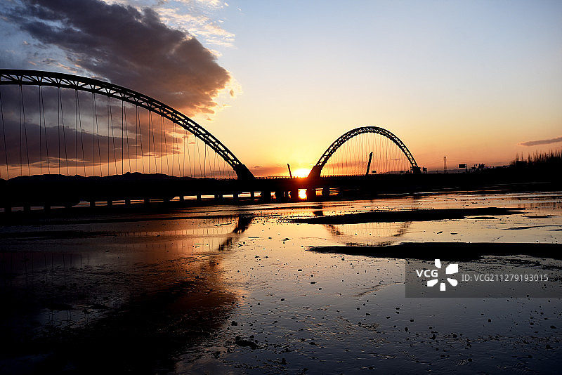 张家口市明湖在晚霞映衬下，水面、桥梁、雕塑构成一幅美丽画卷图片素材