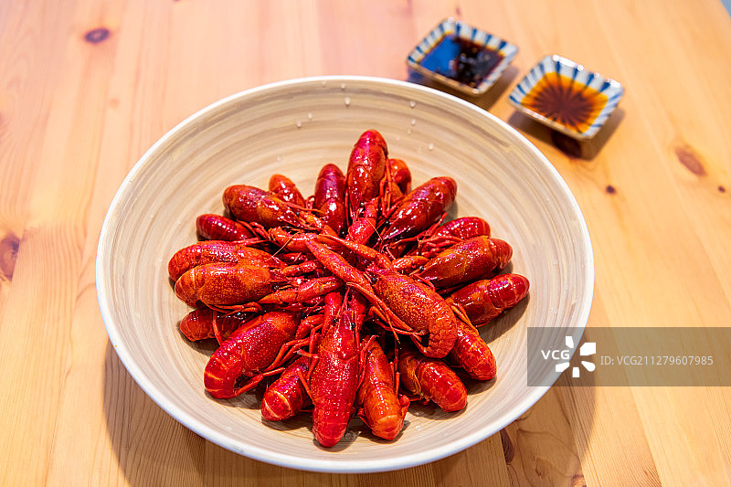 木桌上的一碗小龙虾与酱料正上方视角图片素材
