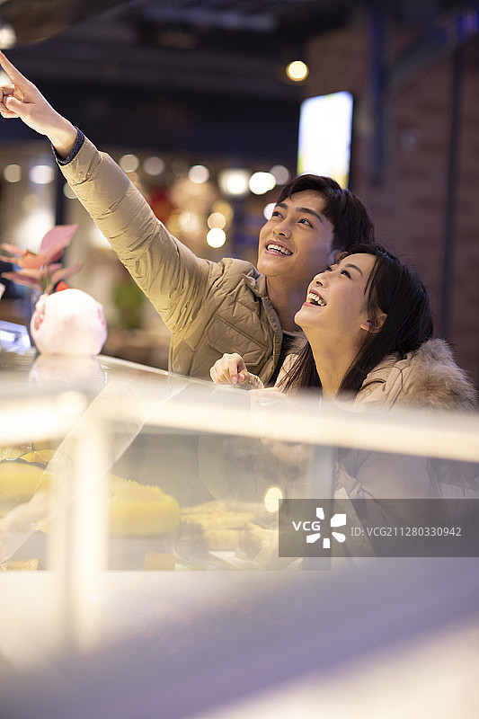 快乐的年轻情侣在商场购物图片素材