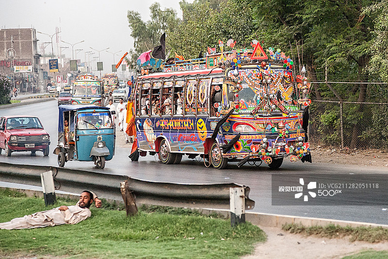 在巴基斯坦白沙瓦的繁忙道路旁睡觉的男子图片素材