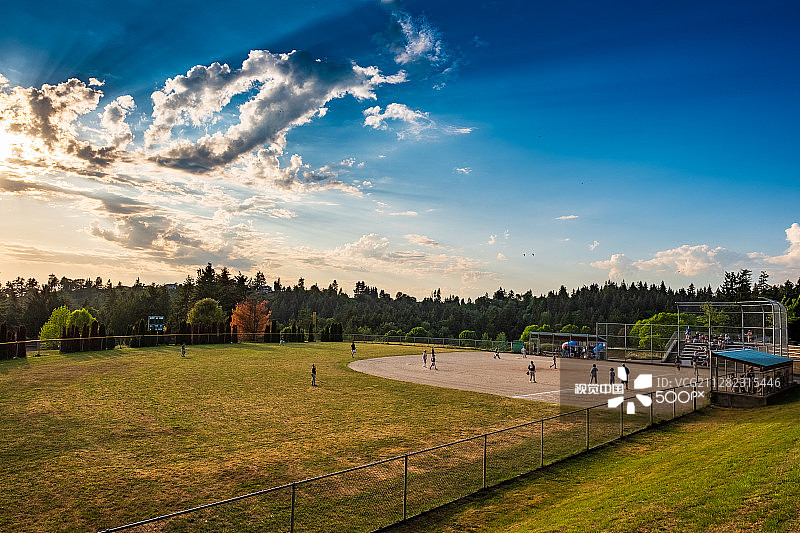 上帝之光洒在小联盟棒球比赛的天空中图片素材