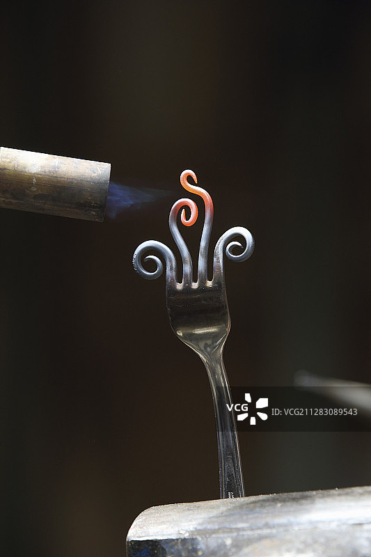 用喷灯加热叉子的尖齿图片素材