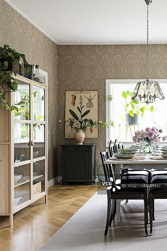 带玻璃柜和复古壁纸的餐厅餐桌图片素材