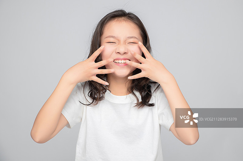 灰色背景里的亚洲小学女生图片素材