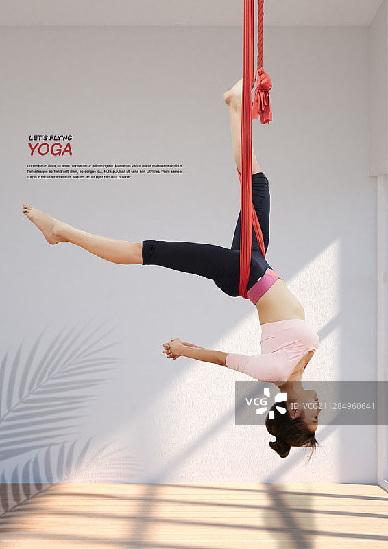 在红色吊床上倒立做空中瑜伽的合成图像图片素材