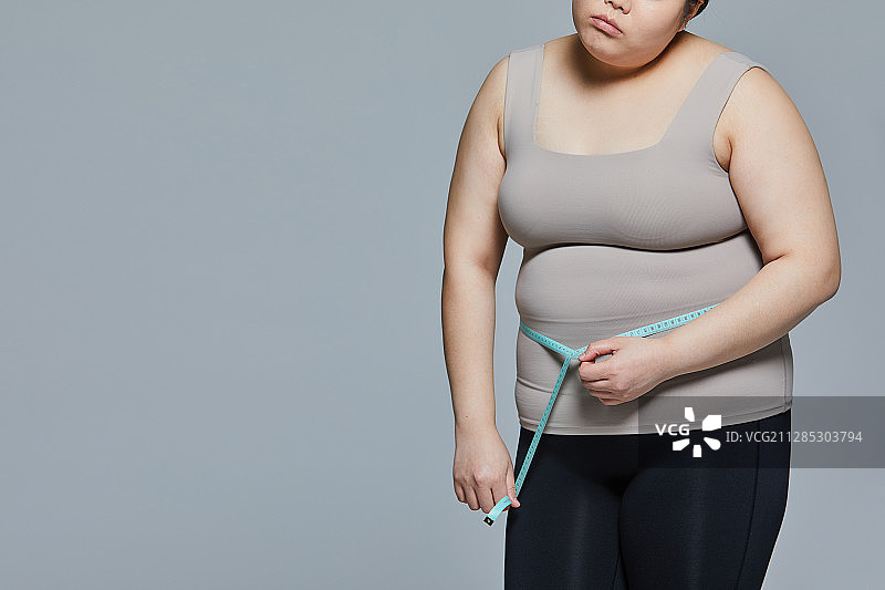 饮食、肥胖、腹部肥胖、腰围、压力、暴饮暴食、贪食症图片素材