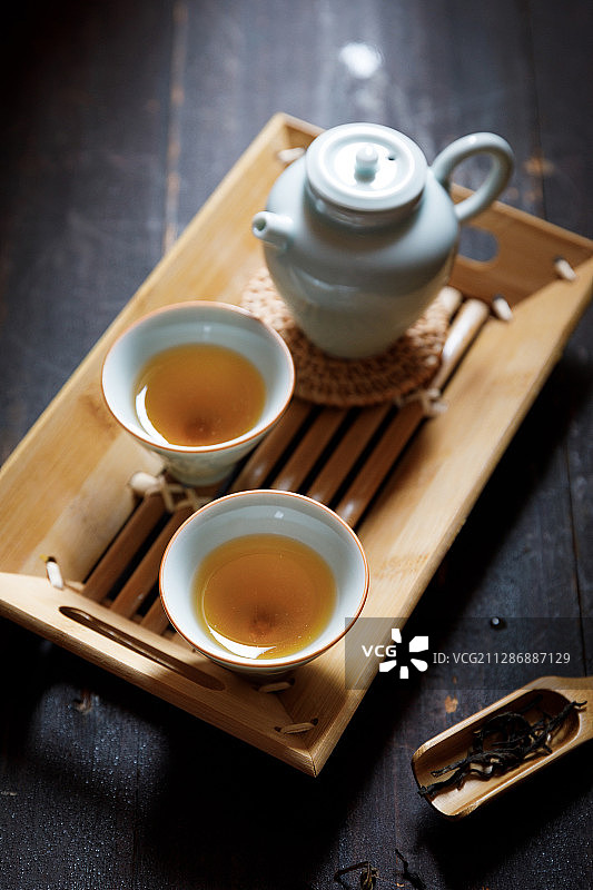 放在茶盘上的两杯乌龙茶和一只茶壶图片素材