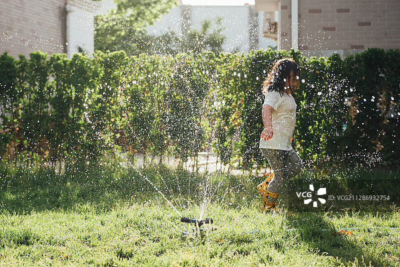 一个亚洲儿童在草地上玩耍图片素材