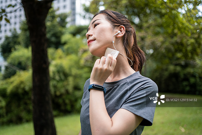 亚洲年轻女性运动后用纸巾擦汗图片素材