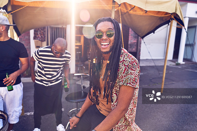 在阳光明媚的停车场与朋友聚会的快乐男人图片素材