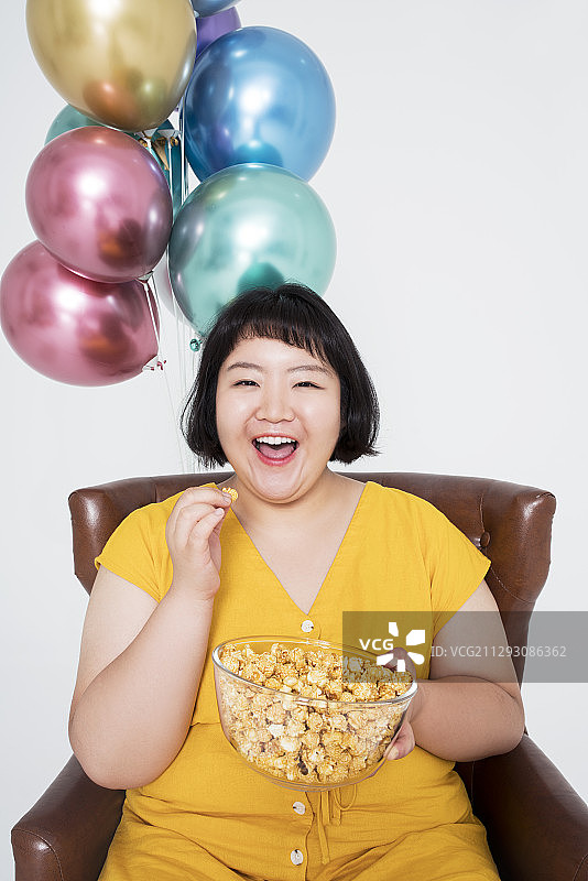 胖女人吃爆米花图片素材