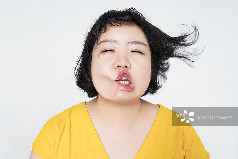 年轻女子脸被风吹变形图片素材