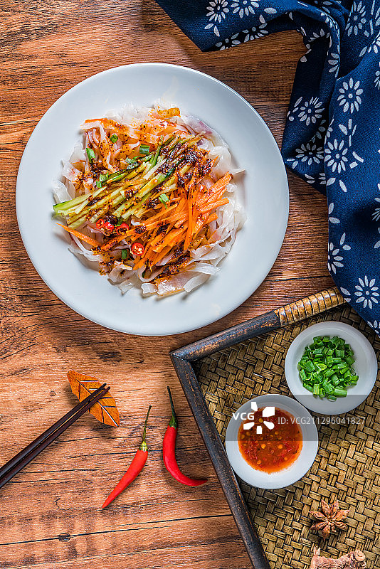 放在木桌上的一盘岐山香辣红油凉皮图片素材