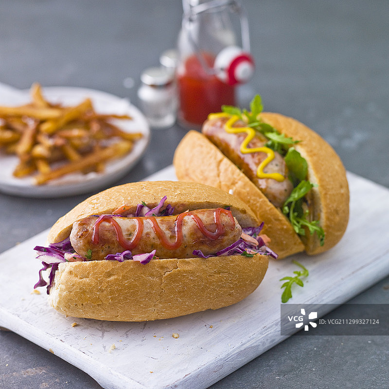 搭配卷心菜沙拉、生菜、番茄酱和芥末的热狗图片素材