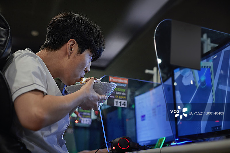 青少年学生在网吧吃零食、方便面图片素材