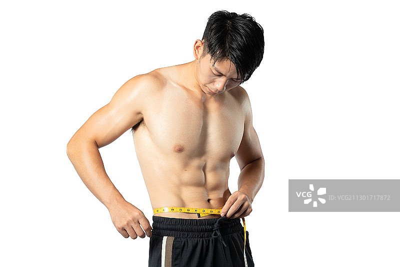 正在测量身材的健身肌肉男孩图片素材