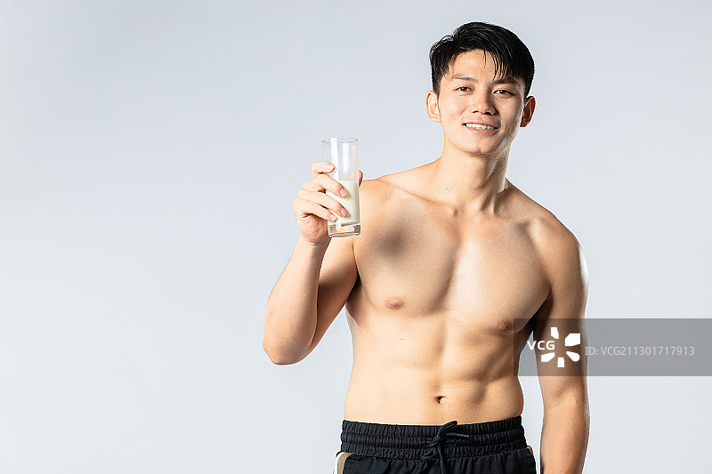 正在喝牛奶的健身肌肉男孩图片素材