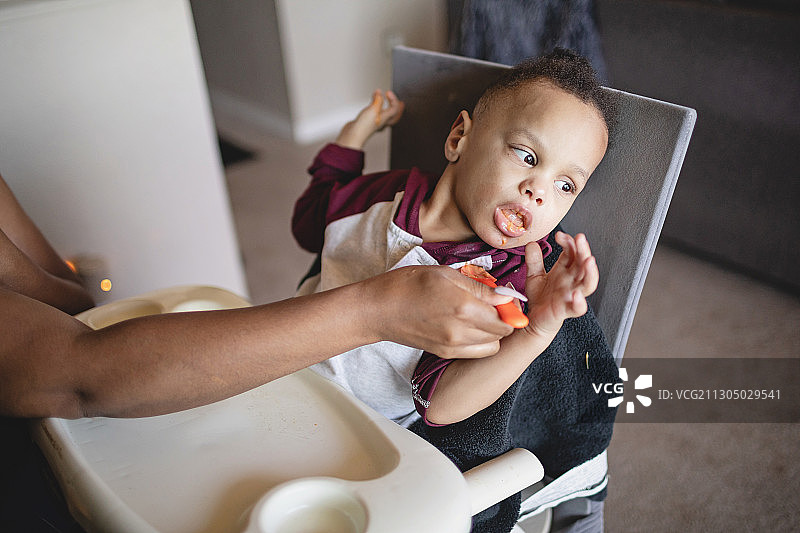 患有脑瘫的非裔美国男孩享受小吃时间，华盛顿州布雷默顿，美国图片素材