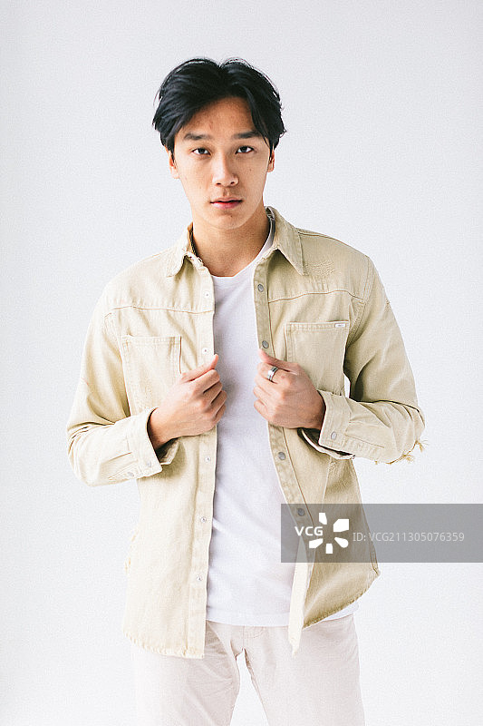 年轻越南男人在工作室穿着白色衣服图片素材