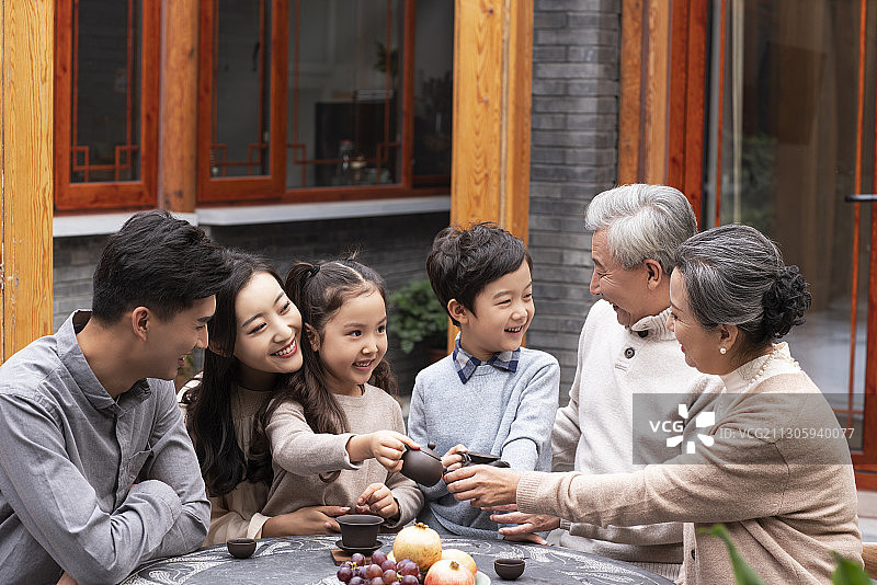 快乐的一家人在院子喝茶聊天图片素材
