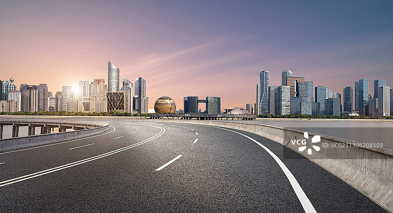 夕阳下杭州r新区城市建筑群及高架柏油路图片素材