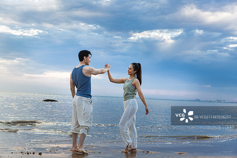 青年情侣在海边做运动图片素材