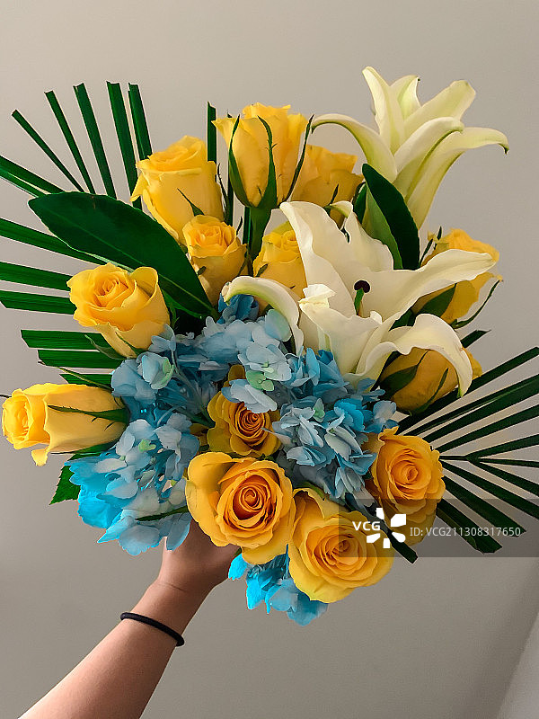 手持花束，背景是墙，美国图片素材