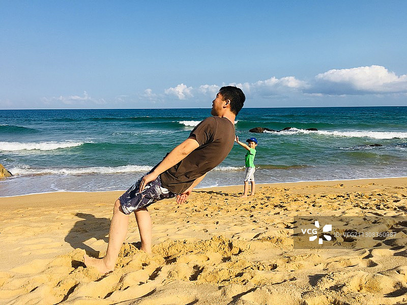 父子两人在沙滩上玩耍图片素材