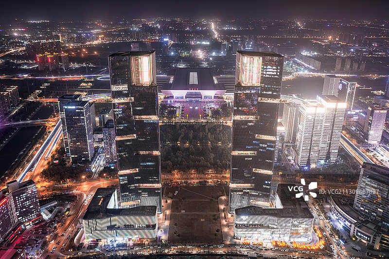 亚洲中国河南省郑州市郑东新区绿地双塔写字楼夜景航拍视角图片素材