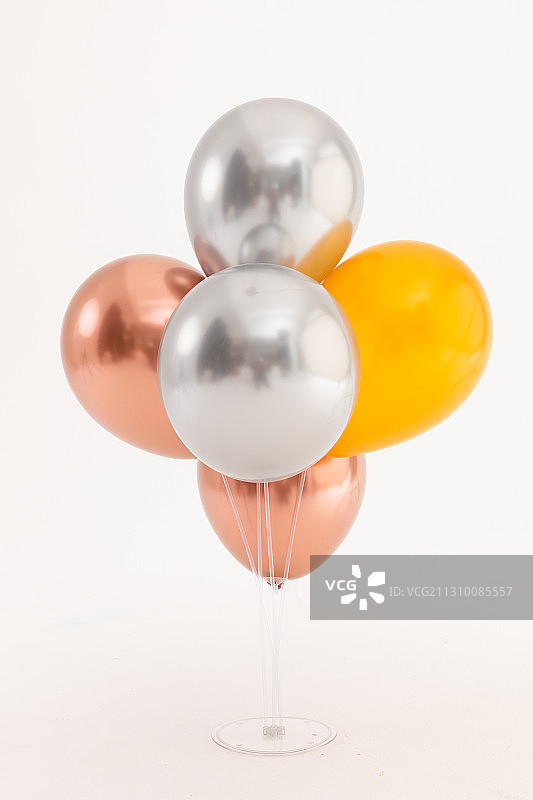 白色背景上的银色、玫瑰金和金色金属气球图片素材
