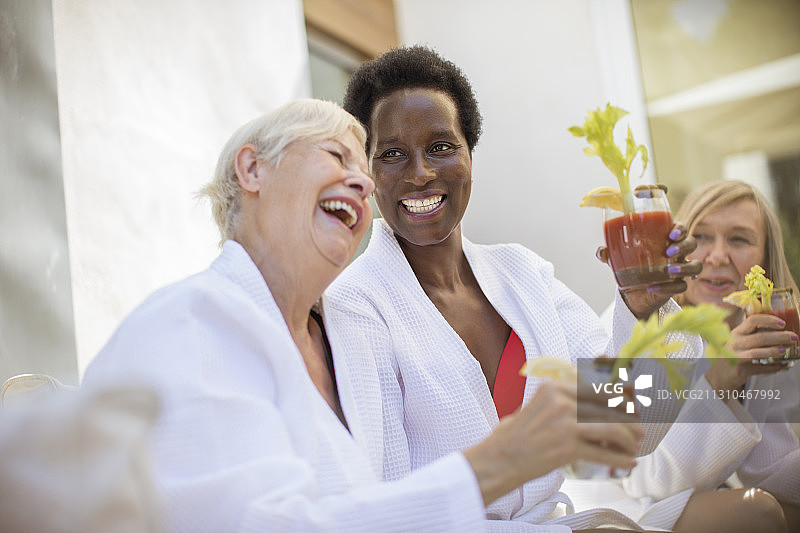 快乐的老年妇女朋友们在享用血腥玛丽鸡尾酒图片素材