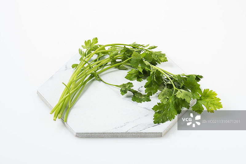 白色背景上白色大理石板上的水芹图片素材