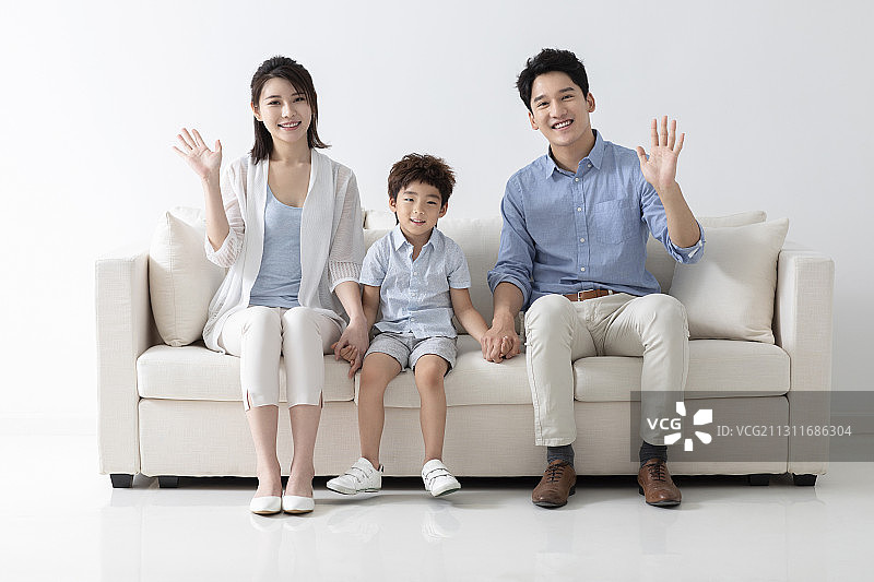 开心的一家三口坐在沙发上图片素材