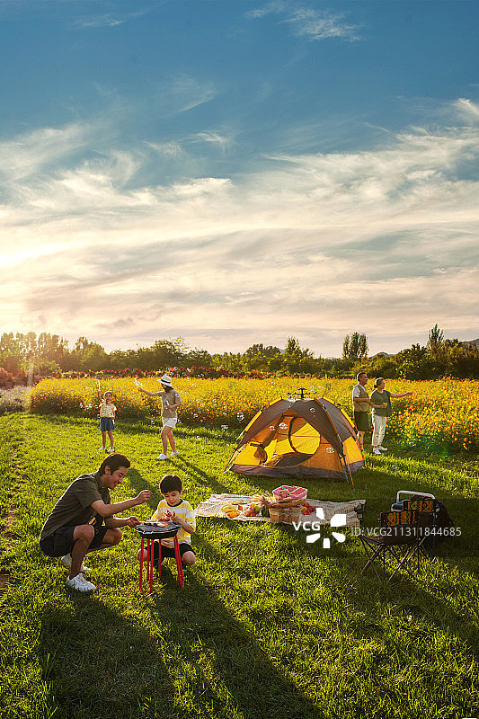 欢乐的一家人在郊外野餐烧烤图片素材