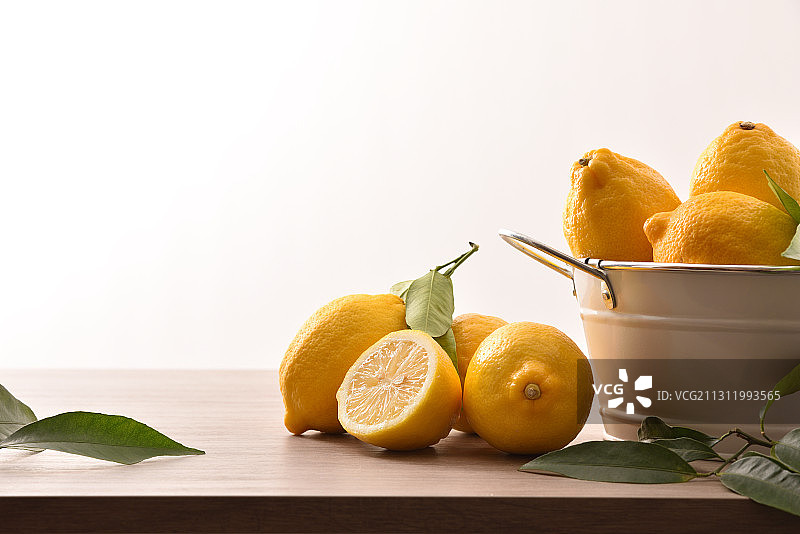 白色背景下桌子上碗里的橙子特写图片素材