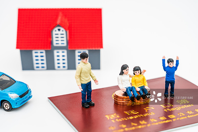 一家四口玩具人偶和房子模型放在户口本上——房地产概念图片图片素材