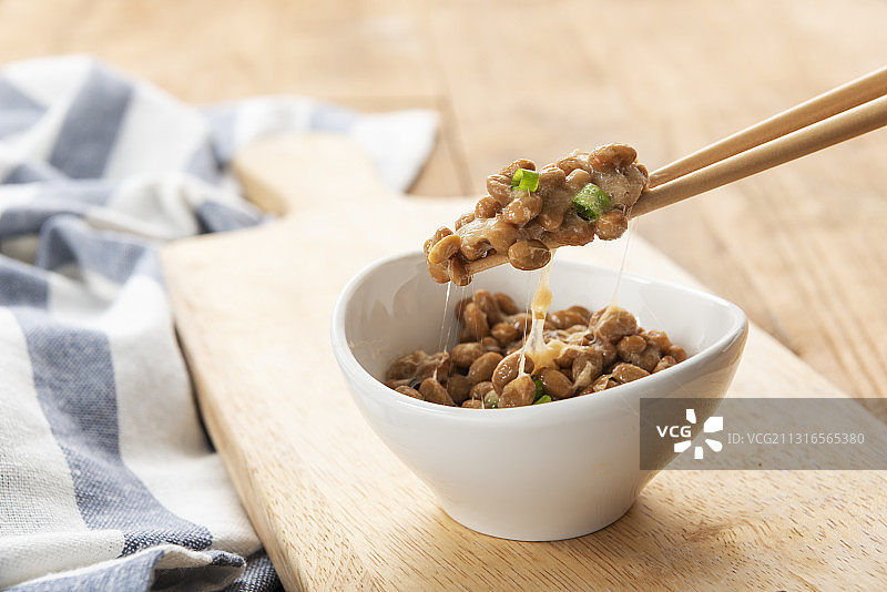 木制砧板和筷子上的碗装纳豆图片素材