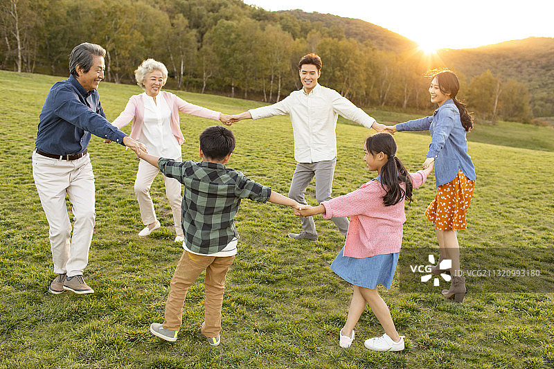 快乐的的家庭在草地上玩耍图片素材