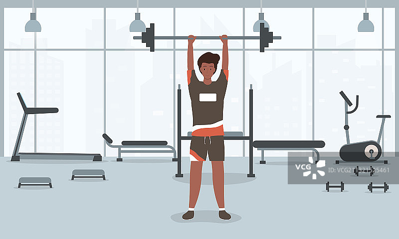 一个年轻健壮的男人在健身房举杠铃图片素材