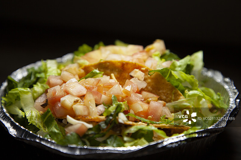 黑色背景下盘子里的美食特写图片素材