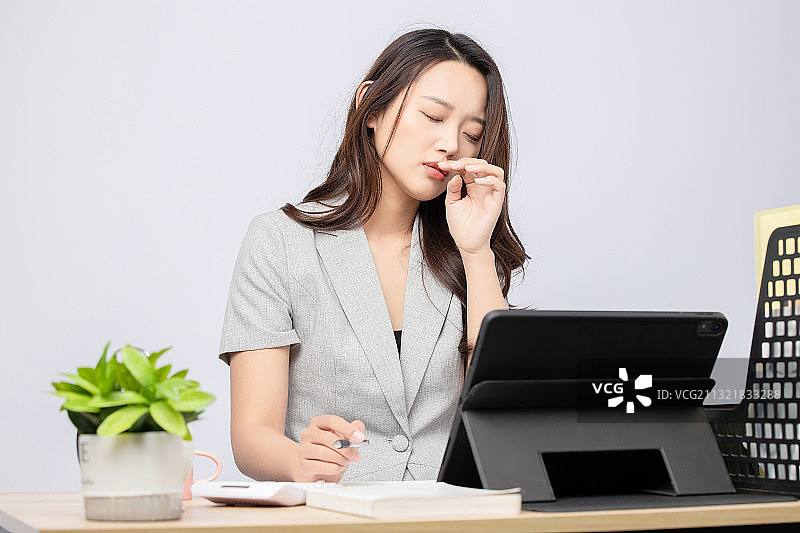灰色背景里正在办公的商务美女图片素材